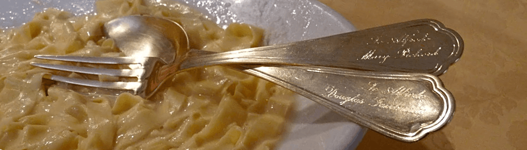 Golden fork and spoon to make fettucine Alfredo