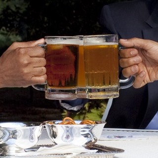 Hands clink beer glasses together