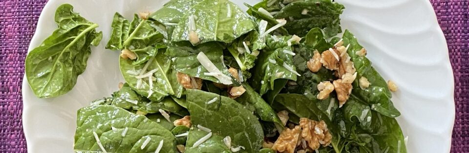 A plate of spinach salad because spinach leaves are high in folate