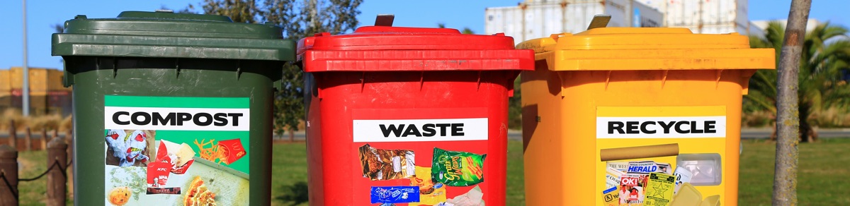 The tops of green, red and yellow waste bins labelled Compost, and RecycleWaste, 